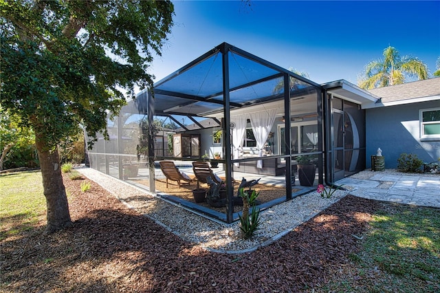 exterior space featuring glass enclosure and a pool