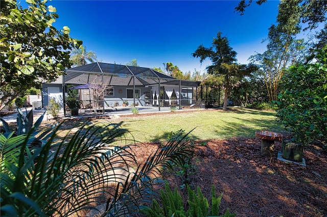 view of yard featuring a swimming pool, a patio area, and a lanai