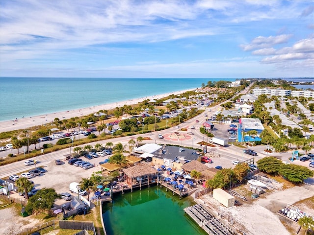 drone / aerial view featuring a beach view and a water view