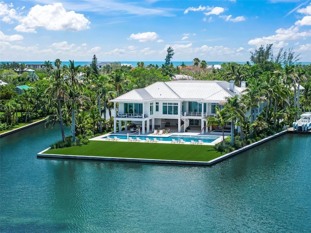 rear view of property featuring a water view, a patio area, a balcony, an outdoor pool, and stairs