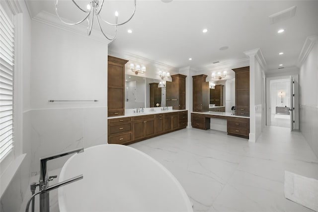 bathroom featuring marble finish floor, crown molding, recessed lighting, a freestanding bath, and vanity