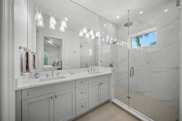 full bathroom with a sink, ensuite bath, and a marble finish shower