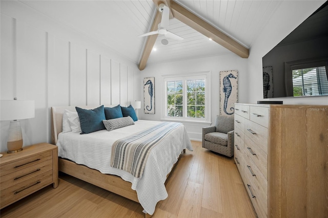 bedroom featuring light wood-style flooring, beam ceiling, and a ceiling fan