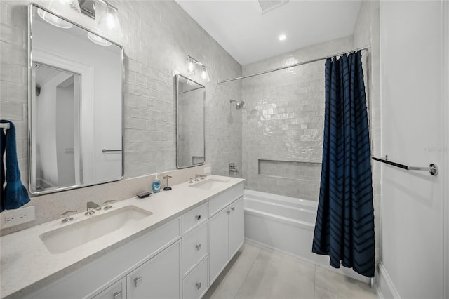 bathroom with shower / bath combination with curtain, double vanity, a sink, and tile patterned floors