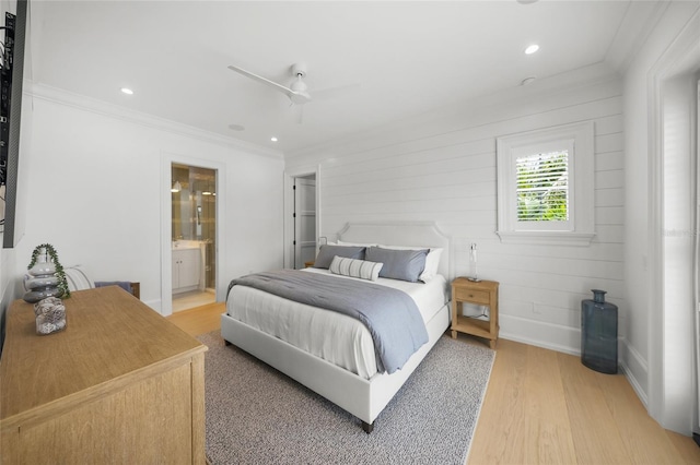 bedroom with baseboards, ensuite bath, ornamental molding, light wood-type flooring, and recessed lighting