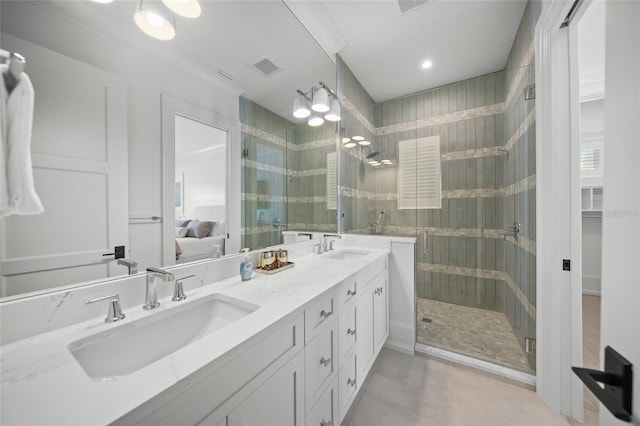 ensuite bathroom with visible vents, a sink, connected bathroom, and a shower stall