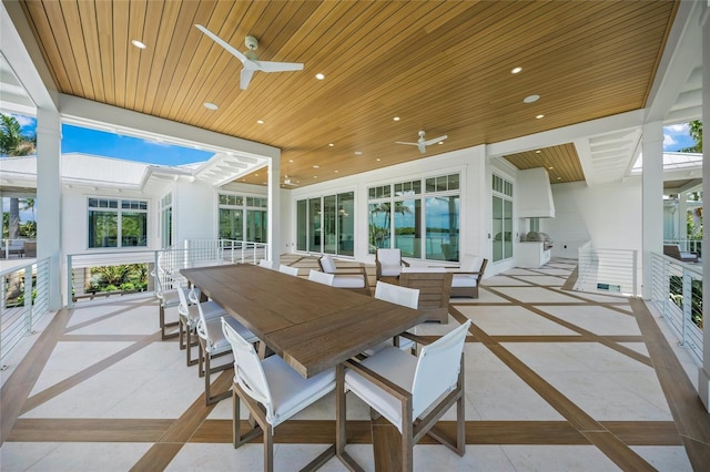 view of patio with outdoor dining space and a ceiling fan