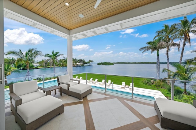 view of patio / terrace featuring an outdoor pool, a water view, and an outdoor living space