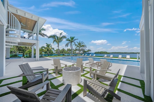 view of patio featuring a water view and a community pool