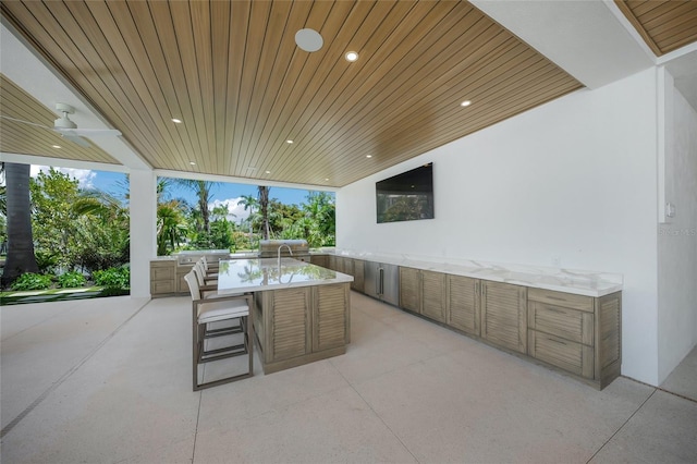 view of patio with outdoor dining space, ceiling fan, grilling area, and area for grilling