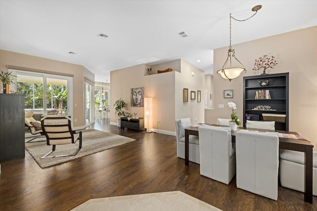 dining room with wood finished floors, visible vents, and baseboards