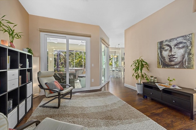 sitting room with baseboards and wood finished floors