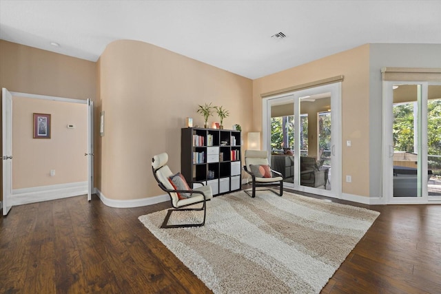 sitting room with plenty of natural light, baseboards, and wood finished floors