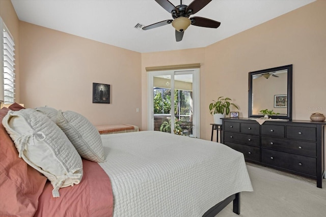 bedroom with a ceiling fan, access to outside, light carpet, and visible vents