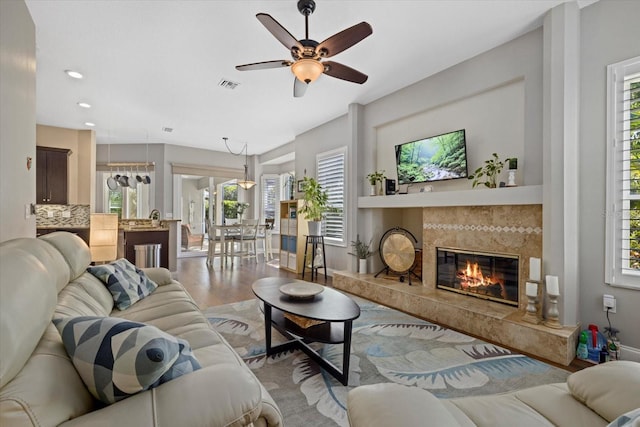 living area featuring ceiling fan, recessed lighting, a fireplace, wood finished floors, and visible vents