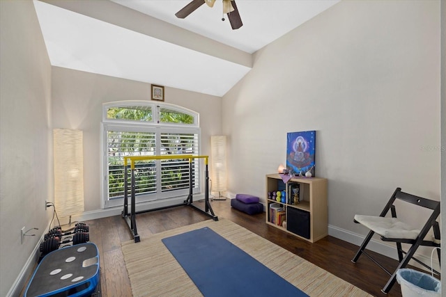 exercise area featuring lofted ceiling, wood finished floors, a ceiling fan, and baseboards