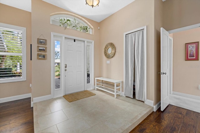 entrance foyer featuring baseboards and wood finished floors