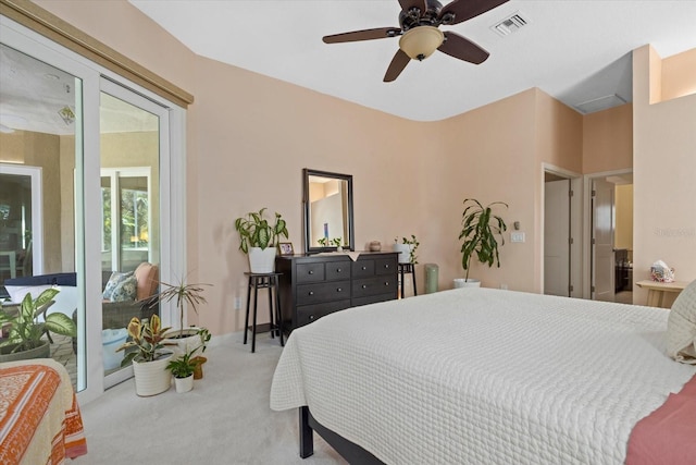 carpeted bedroom with ceiling fan, access to outside, and visible vents