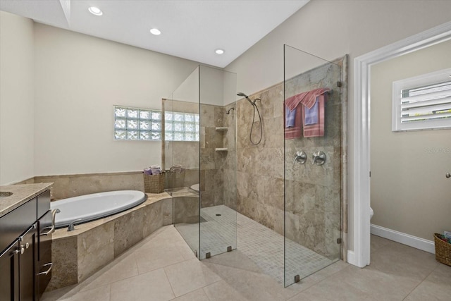 full bath with tile patterned flooring, a garden tub, vanity, and tiled shower