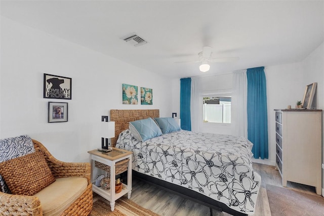 bedroom with ceiling fan, light wood finished floors, and visible vents