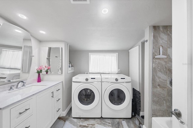 laundry room featuring marble finish floor, recessed lighting, a sink, separate washer and dryer, and laundry area