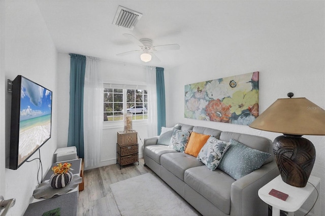 living area featuring ceiling fan, wood finished floors, and visible vents