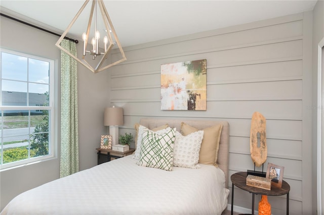 bedroom with a notable chandelier