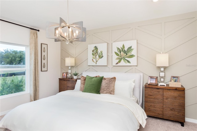 carpeted bedroom featuring an inviting chandelier and a decorative wall