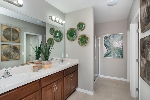 full bath with double vanity, a shower stall, a sink, and tile patterned floors