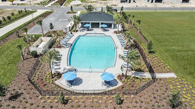 pool with a fenced backyard and a patio