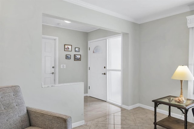 foyer entrance featuring crown molding and baseboards