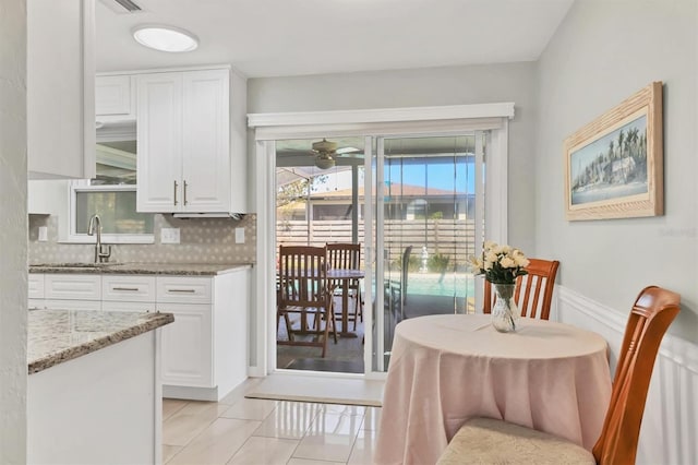 dining area with light tile patterned floors and a ceiling fan