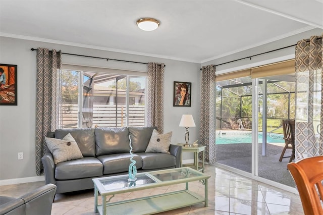 living room with baseboards, a sunroom, and crown molding