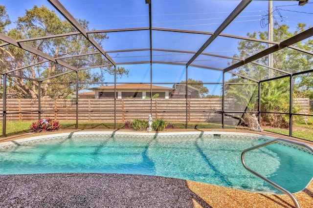 view of pool with a lanai, fence, and a fenced in pool