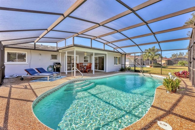 outdoor pool featuring a lanai, a grill, and a patio