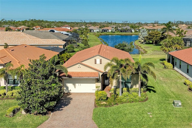 drone / aerial view featuring a residential view and a water view