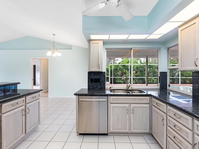 kitchen featuring light tile patterned floors, lofted ceiling, ceiling fan with notable chandelier, a sink, and dishwasher