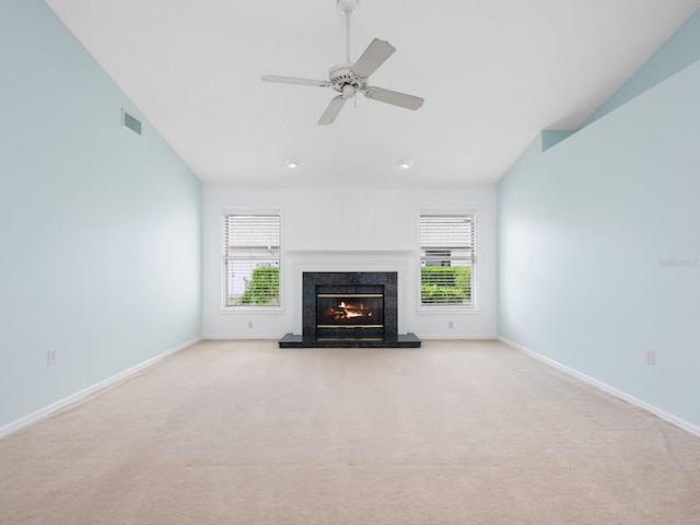 unfurnished living room featuring visible vents, baseboards, ceiling fan, carpet, and a fireplace