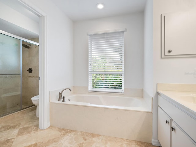 bathroom featuring a stall shower, a garden tub, vanity, and toilet