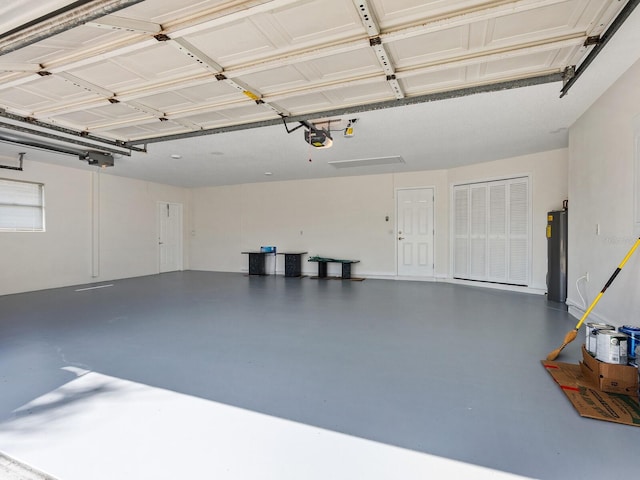 garage featuring water heater and a garage door opener