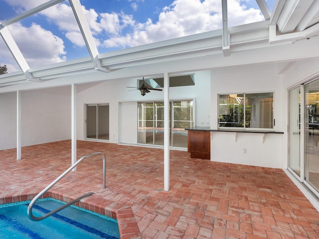 view of patio featuring glass enclosure and an outdoor pool