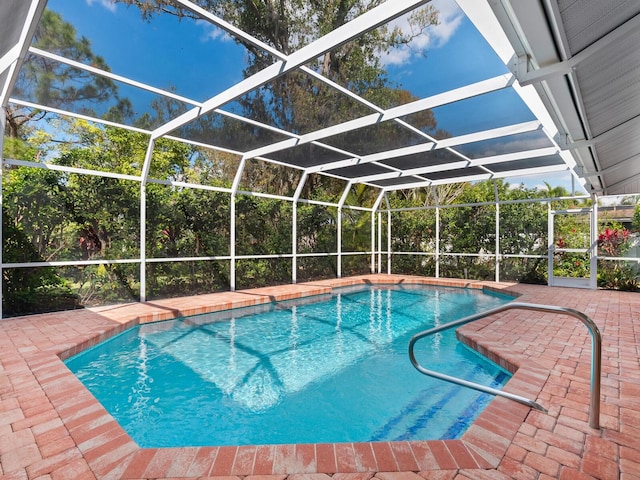 pool featuring a patio area and glass enclosure