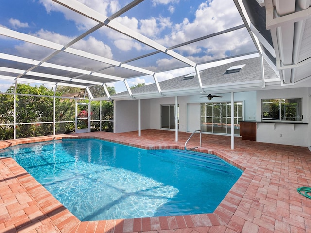 pool with a patio area and glass enclosure