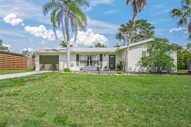 view of front facade featuring an attached garage, driveway, a front yard, and stucco siding