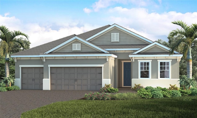 view of front of property featuring decorative driveway, an attached garage, and stucco siding