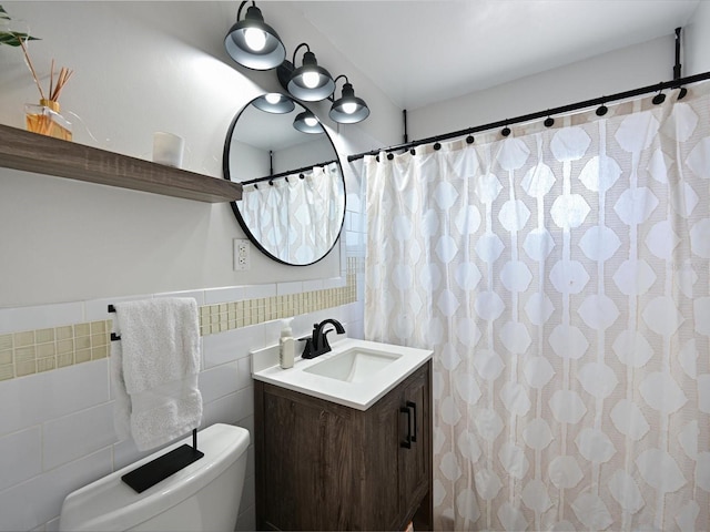 bathroom with toilet, a shower with curtain, tile walls, and vanity