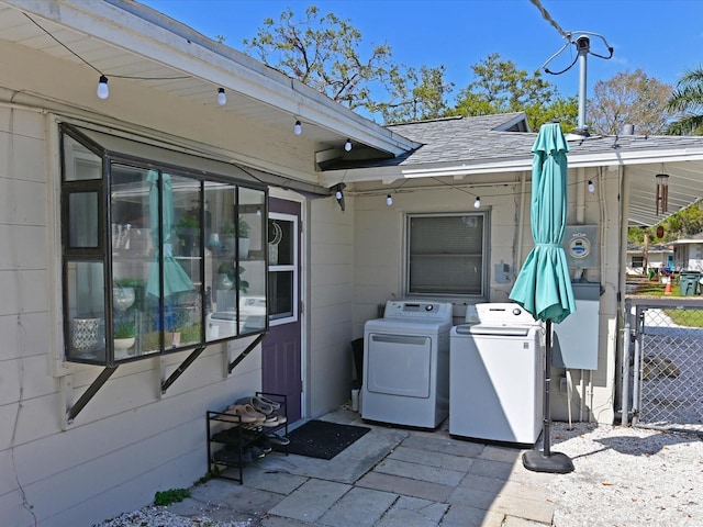 exterior space featuring fence and separate washer and dryer