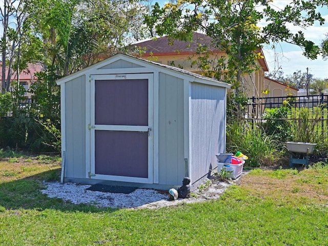 view of shed with fence