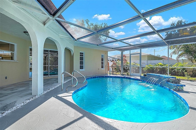 outdoor pool with glass enclosure and a patio