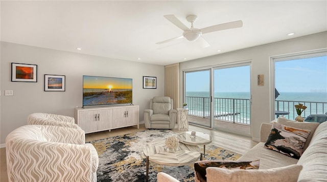 living area featuring a ceiling fan, recessed lighting, baseboards, and wood finished floors